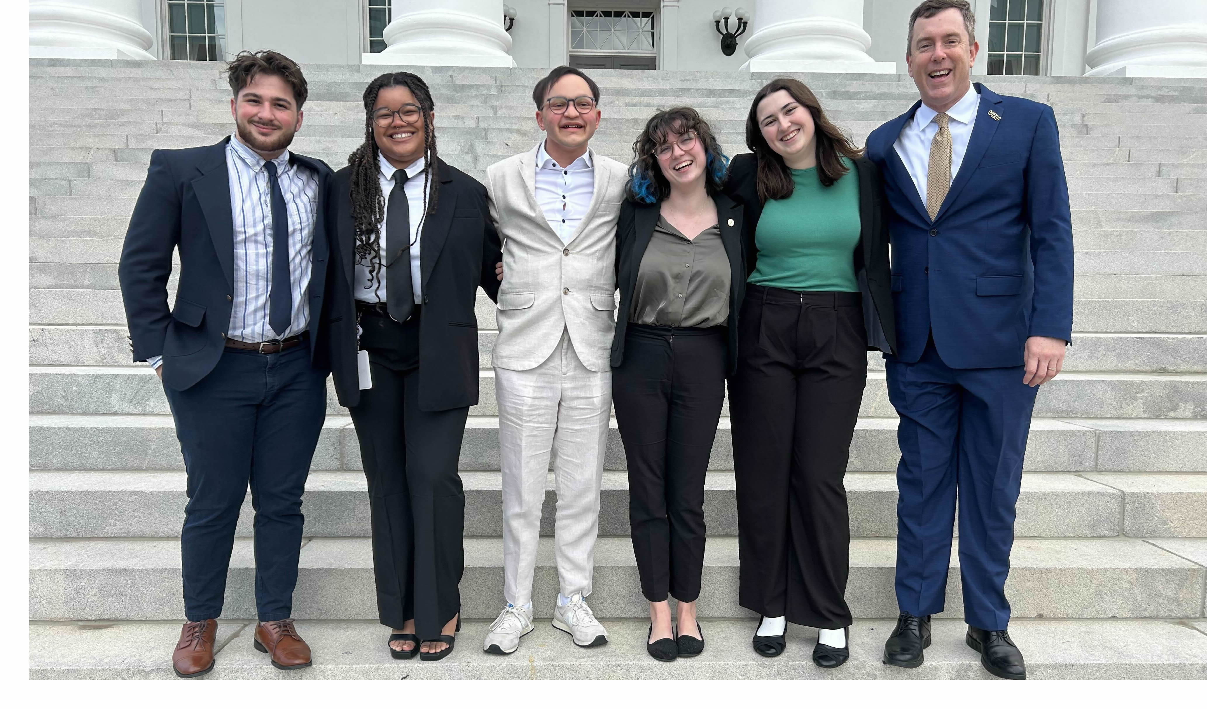 Group of VCU students standing on Capitol steps with a legislator.